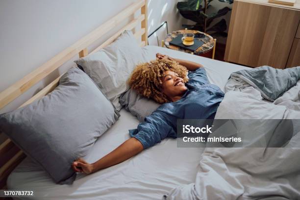 Beautiful Cheerful Woman Having A Lazy Weekend In Bed Stock Photo - Download Image Now