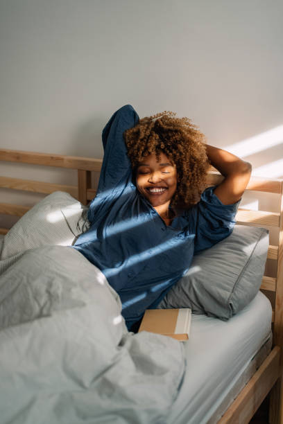 istock Happy Woman Enjoying a Good Read in Bed 1370783746