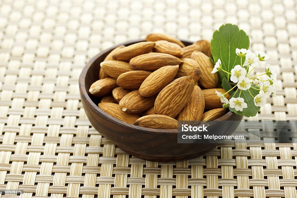 Bowl of Almonds Almonds in small wooden bowl Almond Stock Photo