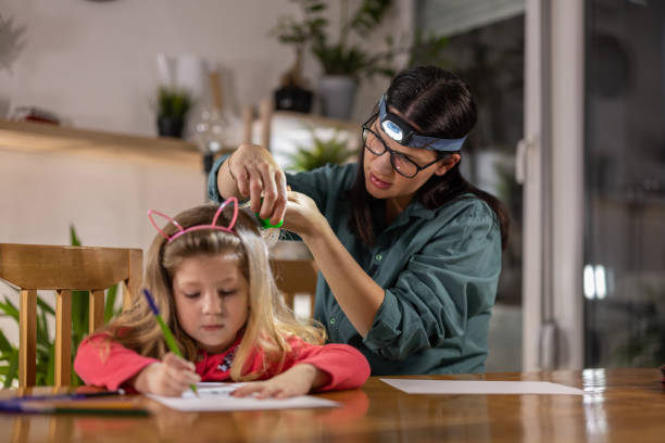 istock Mom searching for lice 1370785572