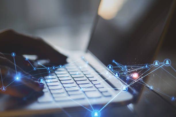 istock Close up of blurry hands at desktop using laptop with abstract glowing polygonal network with people icons. Blurry background. Online networking, multimedia, digital communication concept. Double exposure. 1370785838