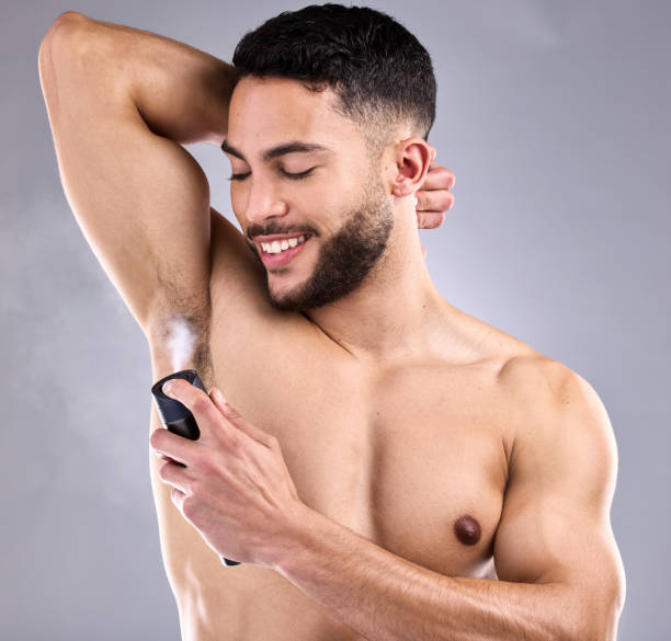 istock Studio shot of a handsome young man spraying deodorant on his armpit 1370790078