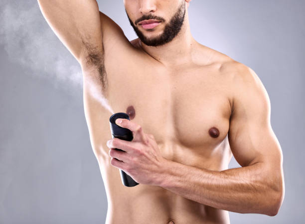 istock Studio shot of a young man spraying deodorant on his armpit 1370790079