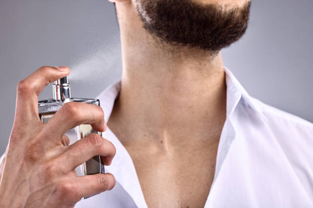 istock Cropped shot of an unrecognizable man spraying perfume on himself 1370790104