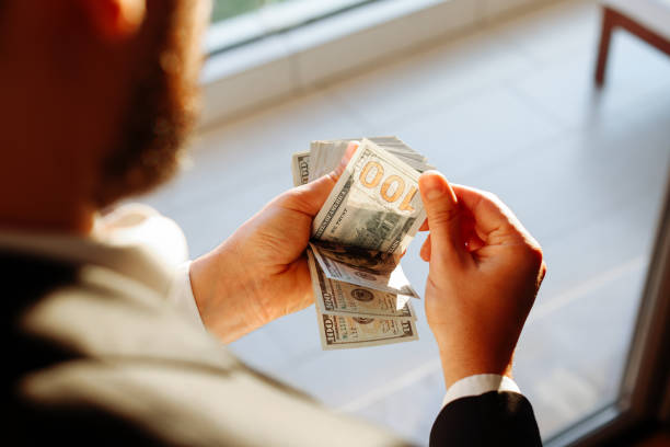 istock Unrecognizable mature man counting USA Dollar bills 1370790913