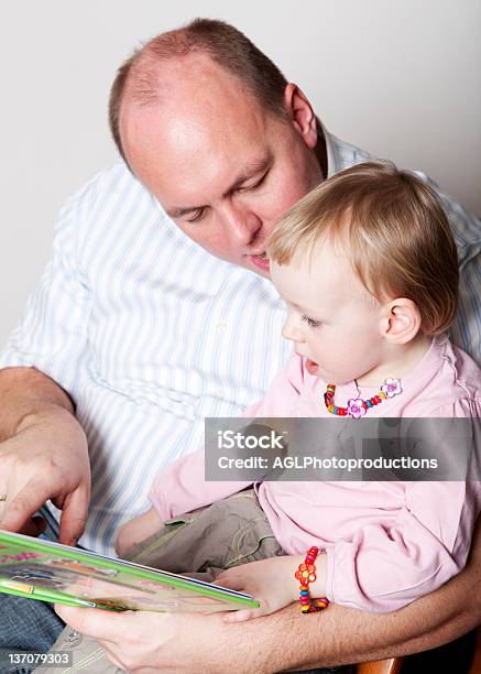 Father And Baby Daughter Reading Stock Photo - Download Image Now - Adult, Affectionate, Baby - Human Age