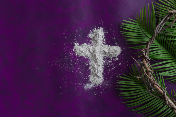 Ash cross, crown of thorns and palms on purple Border of cross of ashes, palm branch leaves and partial crown of thorns on a dark purple background with copy space ash tree photos stock pictures, royalty-free photos & images