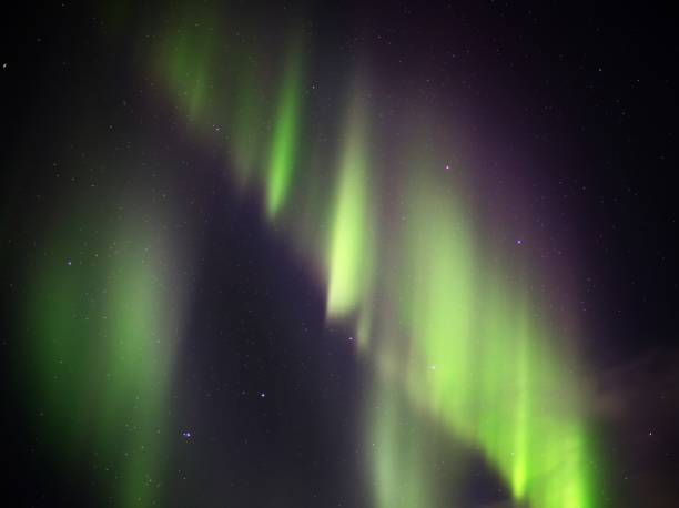 istock Green aurora borealis curtains on night sky 1370793425