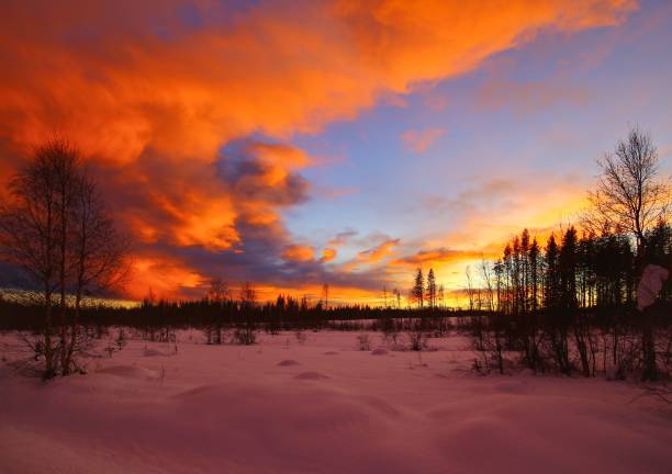 Scenic winter landscape under beautiful orange clouds.