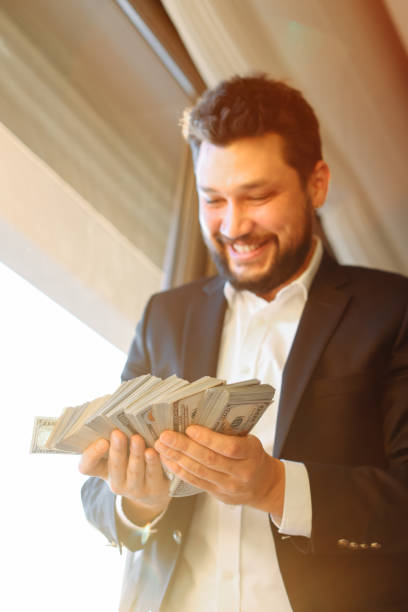 istock Businessman holding US Dollar bills 1370793535