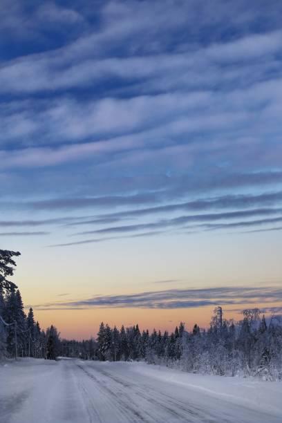 istock Frozen winter road with beautiful evening sky 1370794444