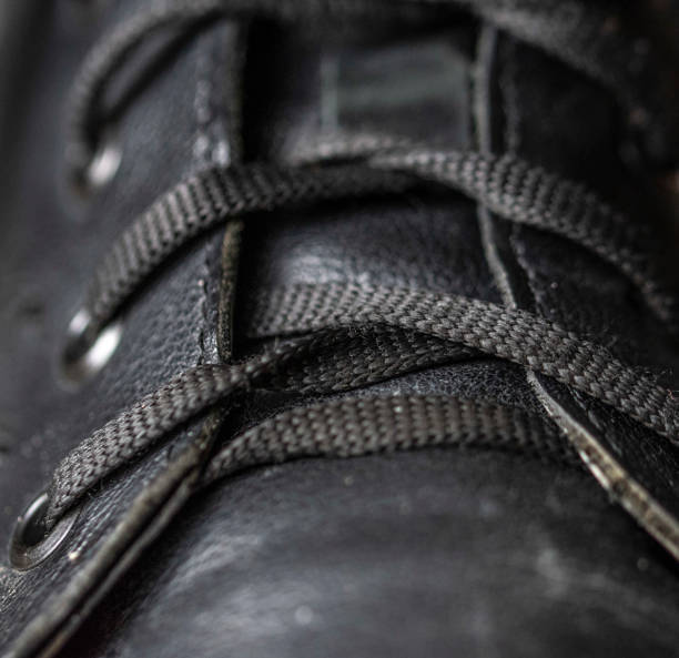istock Old worn-out black shoe close-up 1370800779