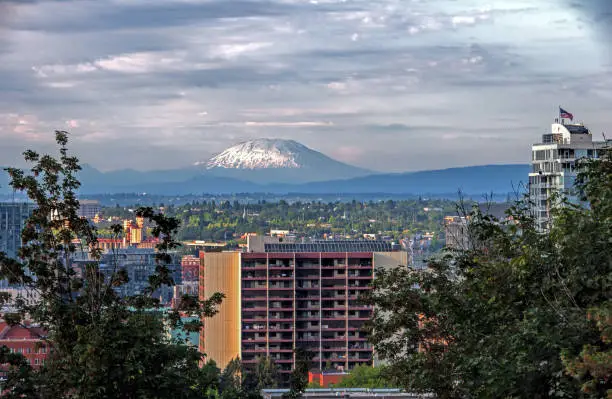 Mount St. Helens glows in the background one summer evening in Portland, Oregon.