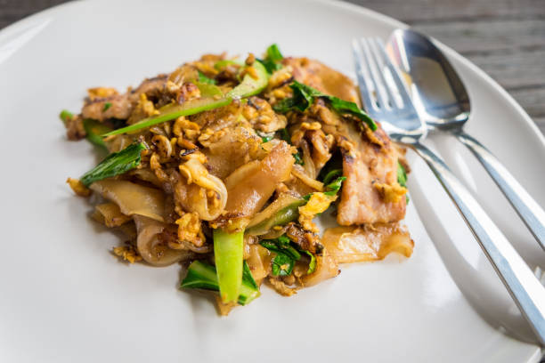 istock Stir fried flat noodle and pork with dark soy sauce 1370811985