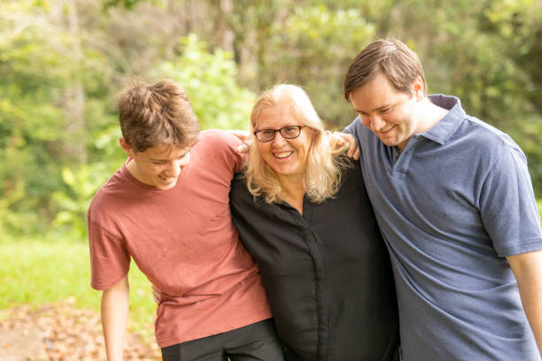 istock Mother hugging her teenage sons 1370814609