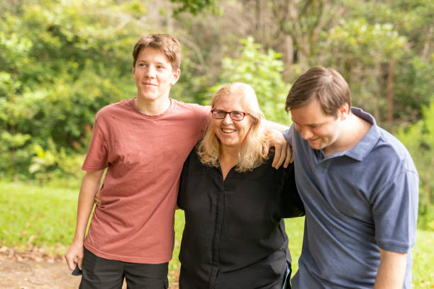 istock Mother hugging her teenage sons 1370814618