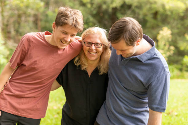 istock Mother hugging her teenage sons 1370814619