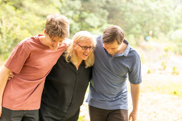 istock Mother hugging her teenage sons 1370814635