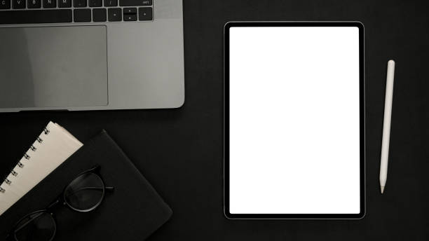istock Minimal black office desktop with digital tablet white screen mockup 1370816586