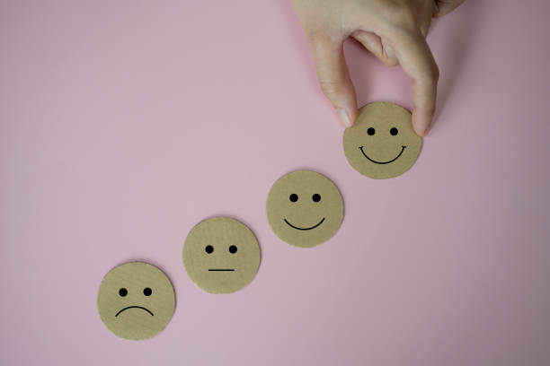 istock Hand holding happy face smile face icon paper cut on pink background 1370817468