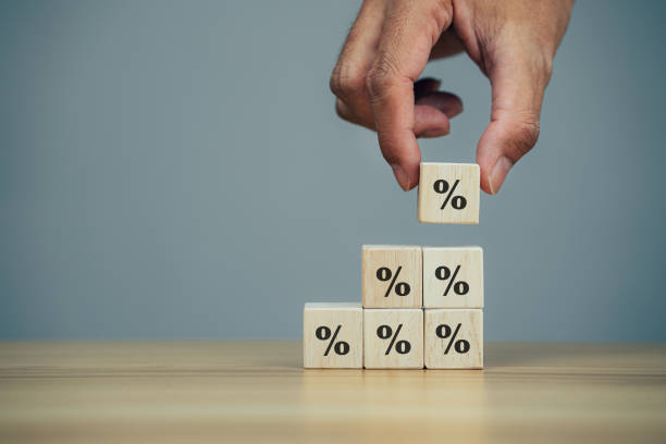 istock Closeup hands putting wooden block cube with symbol percentage 1370817573