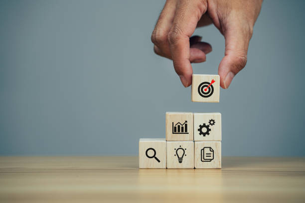 istock Businessman stack woods block step on table with icon business strategy and action plan 1370817574