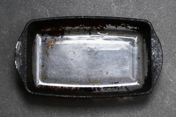 istock Dirty baking dish with thick layer of carbon. Glassware for baking with soot, carbon deposits, old dried fat. 1370820288