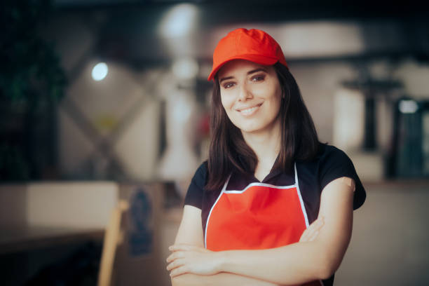 istock Happy Smiling Fast-Food Worker Standing in a Restaurant 1370822349