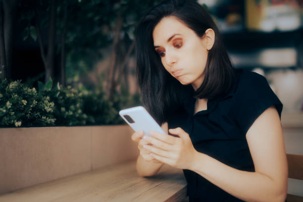 istock Funny Girl Looking Disappointed Reading a Text Message 1370822350