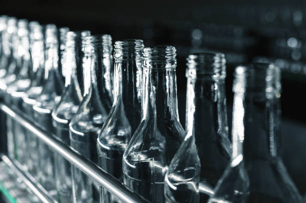istock Row of glass bottles to fill with expensive alcohol drinks 1370823213