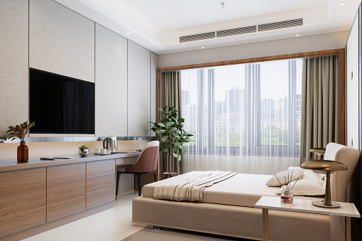 Moderna habitación de hotel con cama doble, mesas de noche, televisor y paisaje urbano desde la ventana photo
