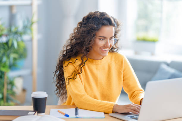 istock woman working on laptop at home. 1370830890
