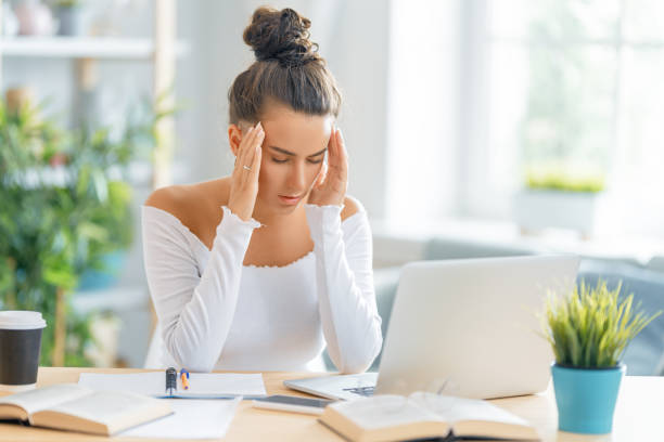 istock Young woman studying and having a head ache 1370830994