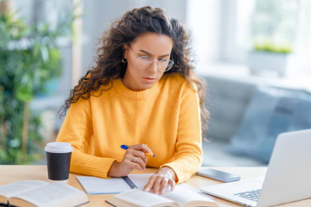 istock woman working on laptop at home. 1370831023