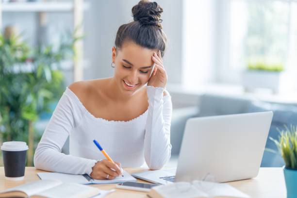 istock woman working on laptop at home. 1370831108