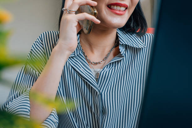 istock Beautiful Asian business woman using smartphone while working at office 1370832276