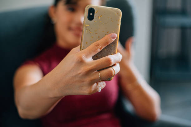 istock Beautiful Asian business woman using smartphone while working at office 1370832333