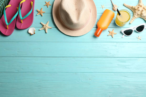 istock Beach accessories on light blue wooden background, flat lay. Space for text 1370837555