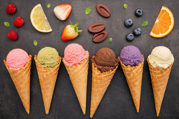 istock Flat lay ice cream cones collection on dark stone background . Blank crispy ice cream cone with copy space for sweets menu design. 1370839512
