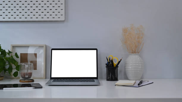 istock Home office desk with mockup computer laptop, houseplant and picture frame. 1370840045