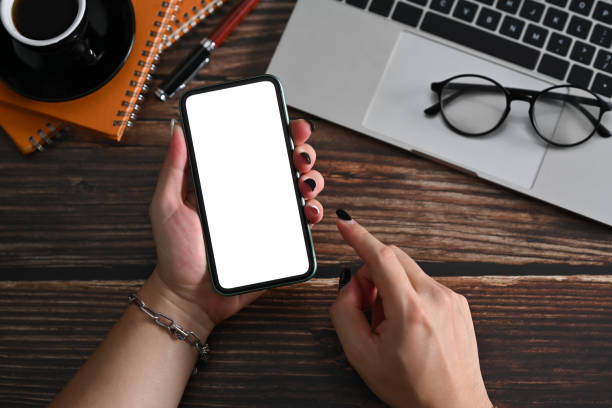 istock Close up view stylish man hand holding smart phone with white screen. 1370840058