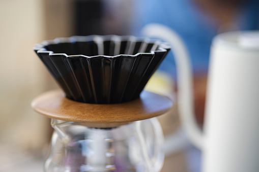 Close up of coffee dip tool , Coffee dip cone on the glass jar