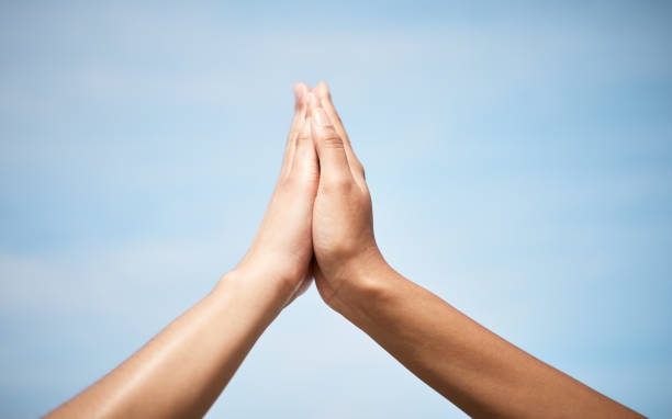 istock Low angle shot of two unrecognizable women highfiving outside 1370844865