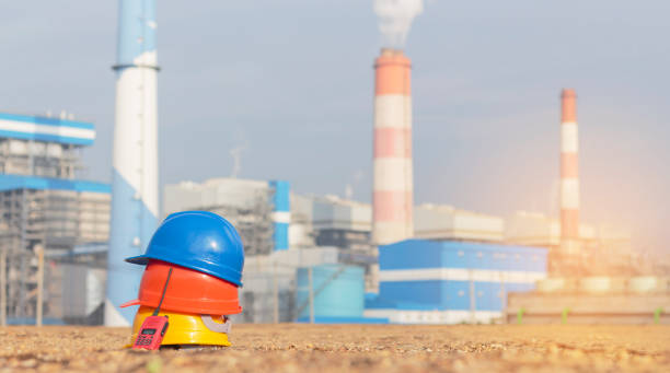 istock Yellow, blue and red helmets with walkie-talkies. In projects, on-ground power plants, helmets for working people as engineers or workers. safety first concept 1370847136