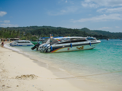 Tourist speed boats near the sandy shore. Boats for fishing and sea tours. Travel.