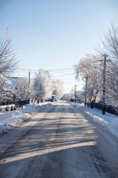 istock Small streets and trees in town covered in snow 1370848761