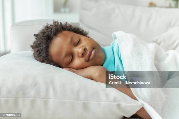 Cute Little African American Boy Child Sleeping In Bed Stock Photo - Download Image Now