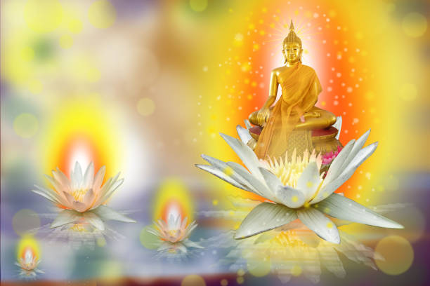 istock Buddha statue sitting on a pink lotus flower . 1370850323