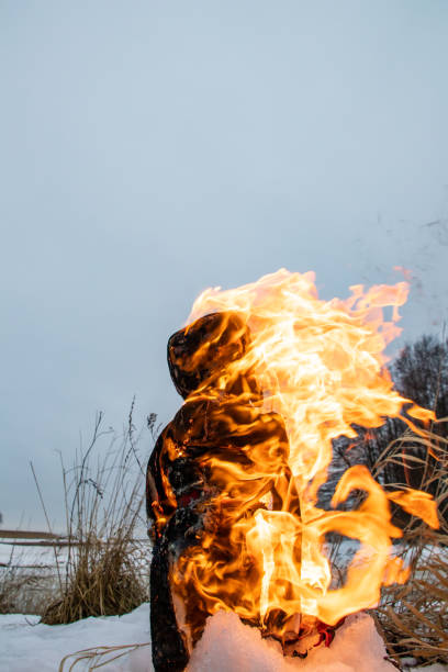 Burning of effigies of straw Maslenitsa on fire on a traditional national holiday. Celebration of Maslenitsa in the Russian village.