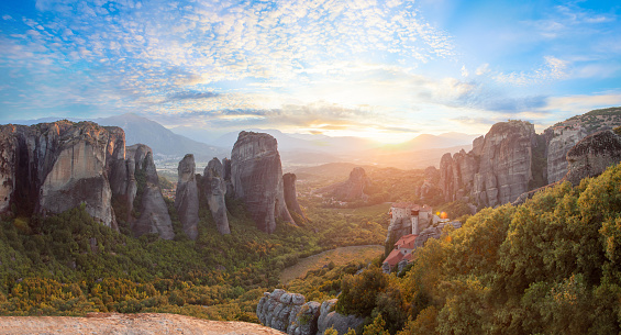 Wonderful view of the rocks and monasteries of Meteora, Greece. Beautiful sunny morning with blue sky and white clouds at sunny day